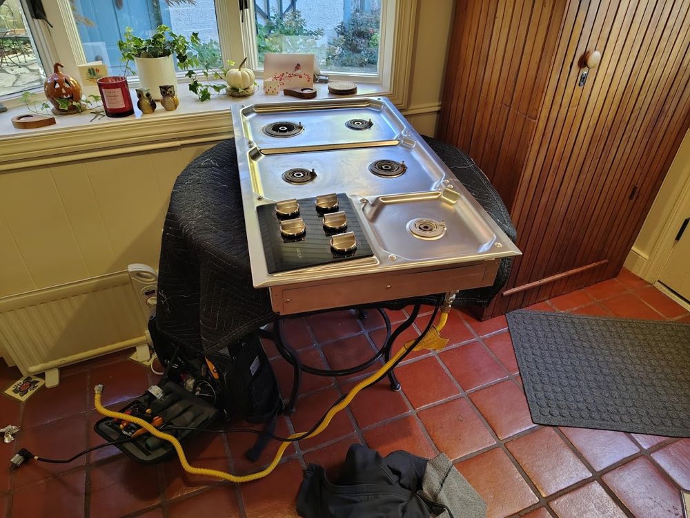 Gas cooktop lifted out of the counter for repair