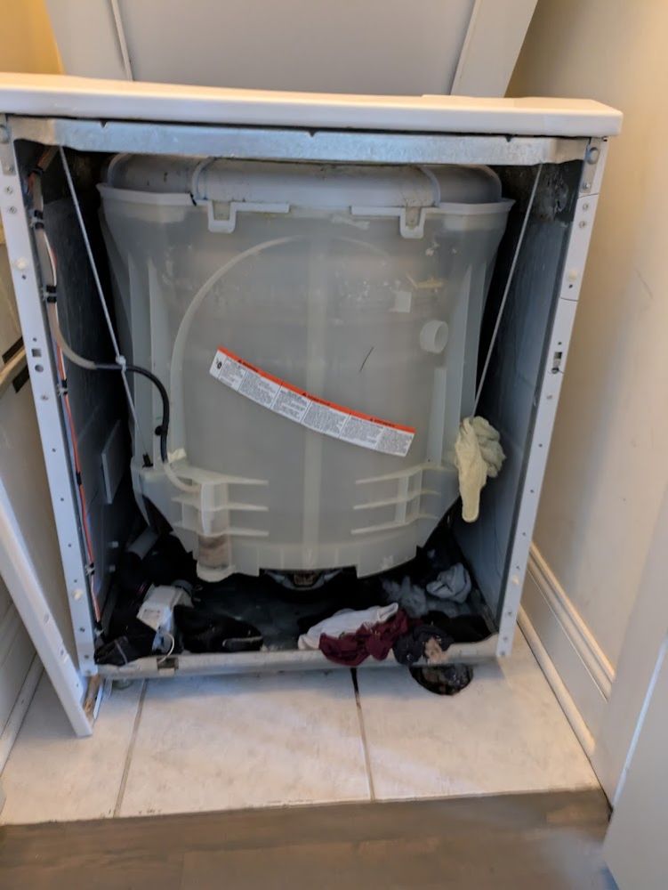 Top-load washer with the cabinet off for repair
