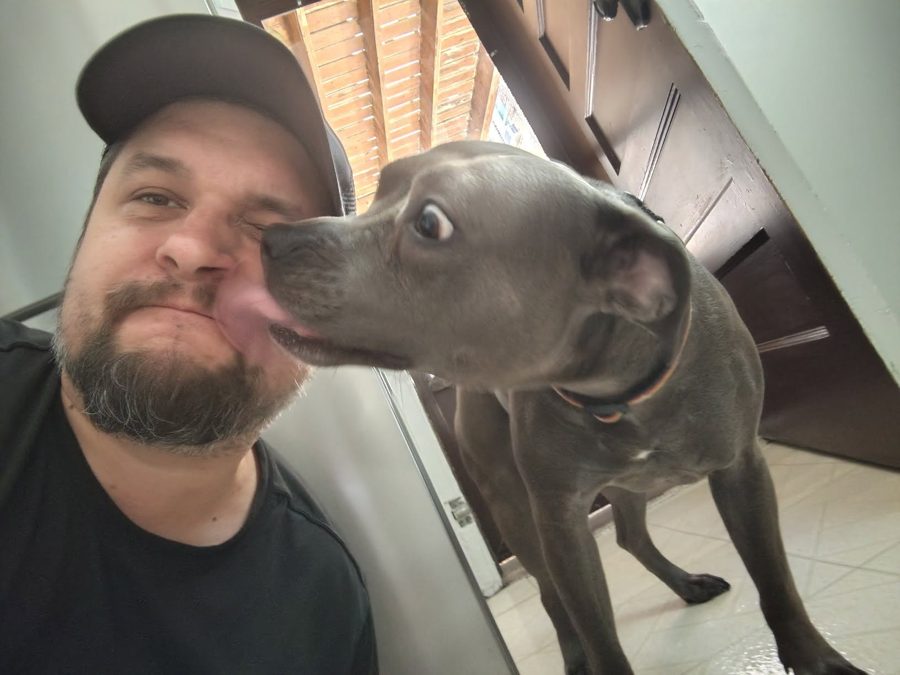 Max getting a kiss from a customer's dog