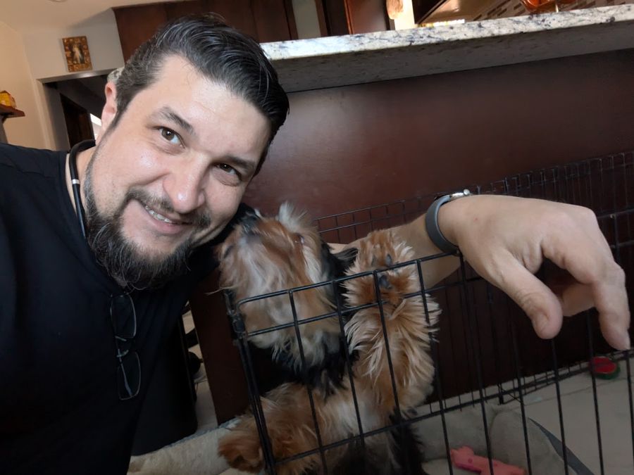 Max with a customer's little dog in its crate