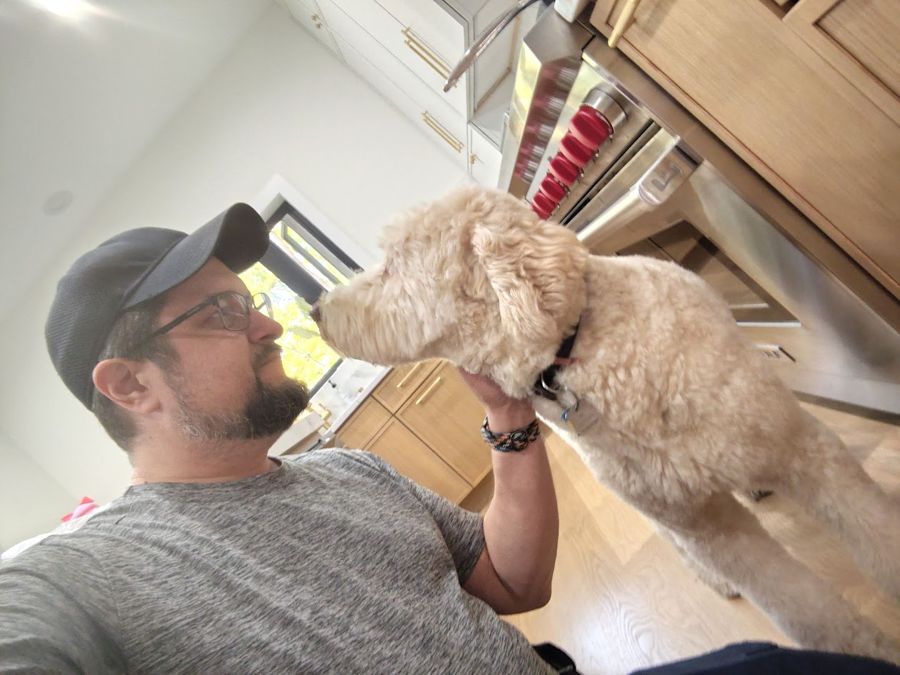 Max saying hi to a customer's fluffy dog